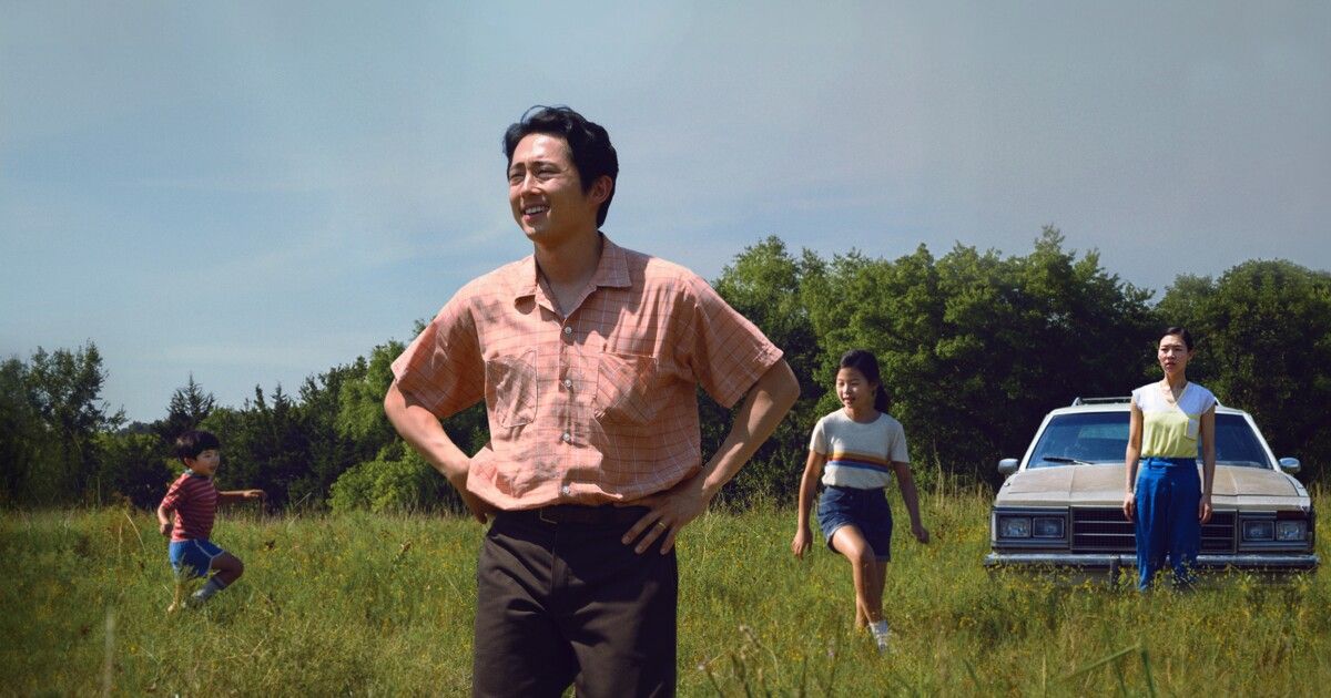 Minari the family plays in the grass as the dad looks onward.jfif