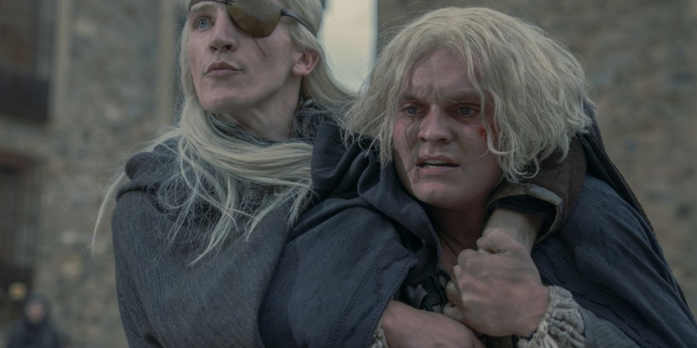 Aemond holding onto his brother Aegon in House of the Dragon. 