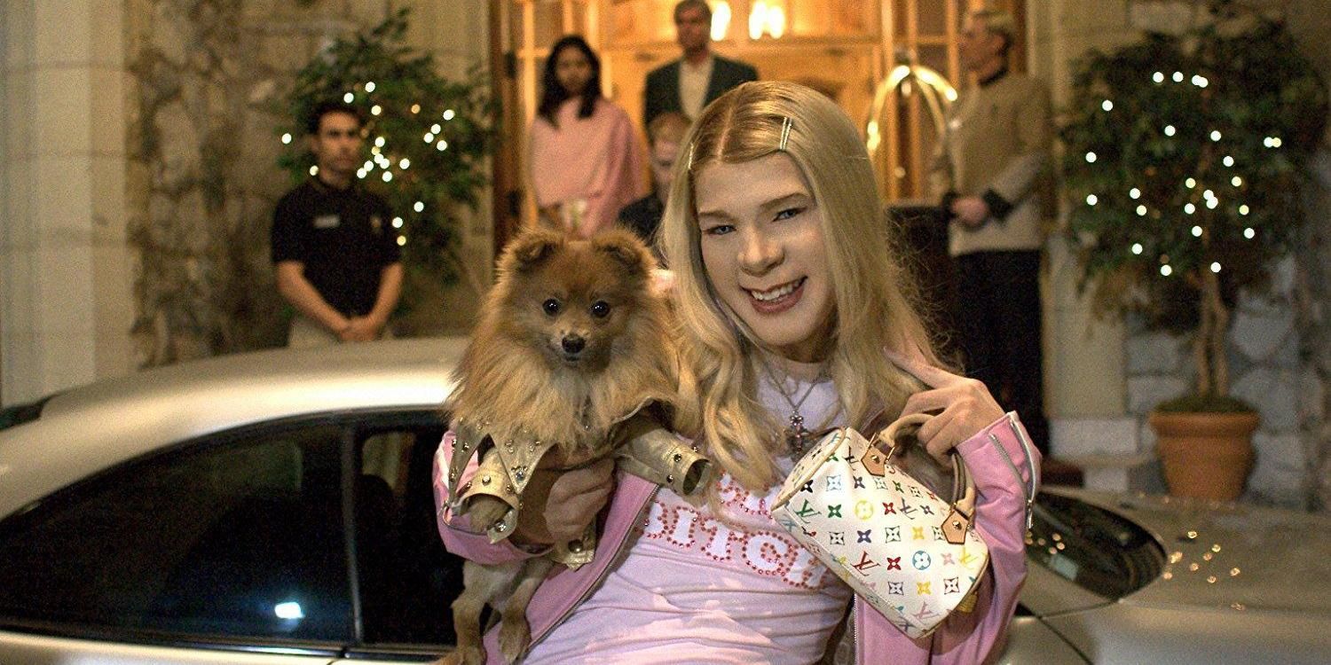 Marcus holding up his dog and bag in White Chicks.