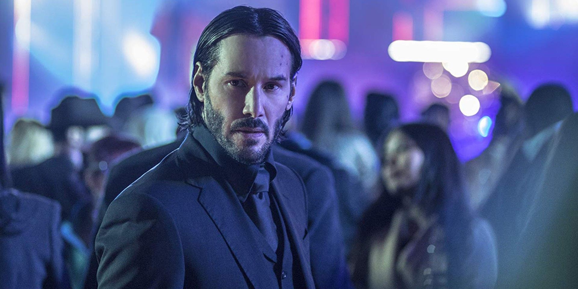 Keanu Reeves as John Wick in a crowd.