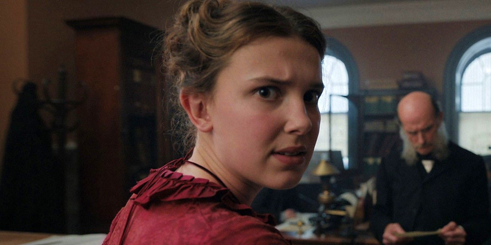 Enola Holmes looks back at the camera incredulously