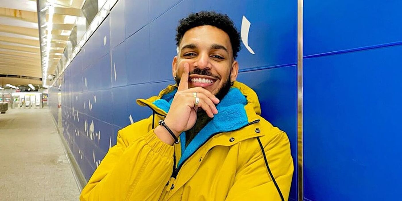 90 Day Fiance star Jamal Menzies wearing yellow jacket and smiling