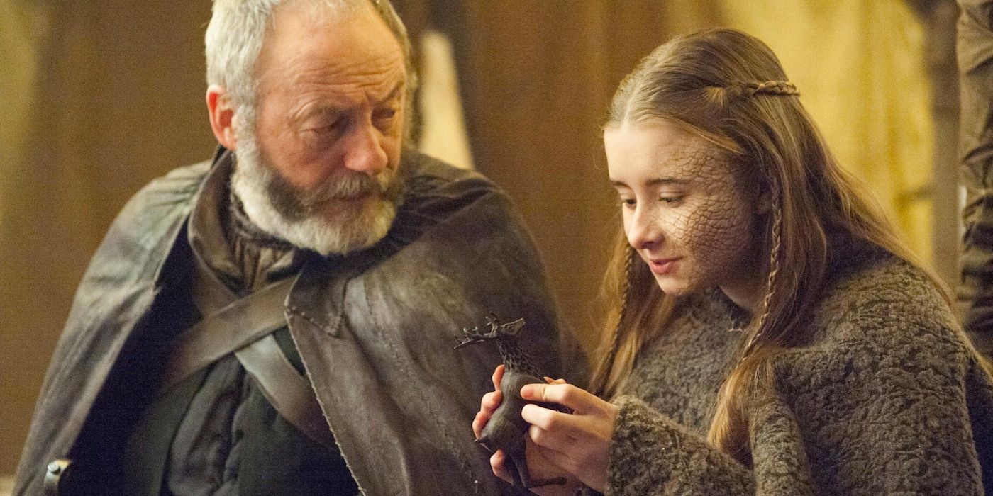 Davos and Shireen with a little carved stag in Game of Thrones